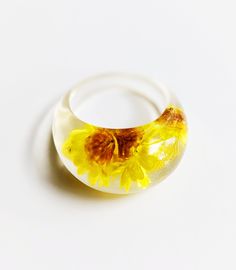 This pretty resin ring has a sweet yellow flower detail, and is the perfect summer accessory. Resin rings are so comfortable and on-trend… we love them!Approximate ring size 6. Classroom Style, Flowers Resin, Resin Rings, Spring Accessories, Flower Resin, Resin Ring, Flower Detail, Rings Bracelets, Spring Tops