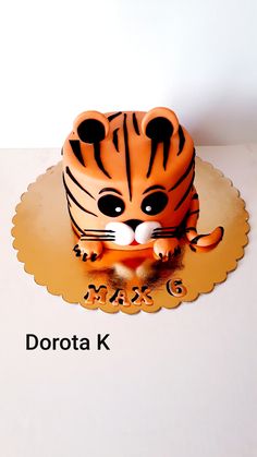 a cake shaped like a tiger sitting on top of a table