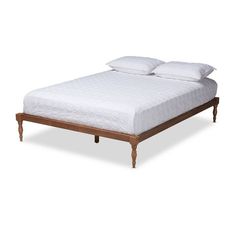 the bed is made up with white sheets and pillows on top of it, but no headboard or foot board