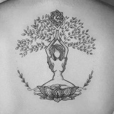 the back of a woman's neck with a tree tattoo on it