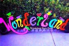 a sign that says wonderland on it in front of some bushes