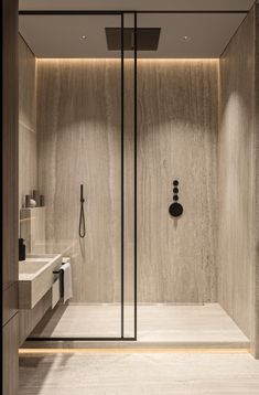 a bathroom with a walk in shower next to a white sink and counter top area