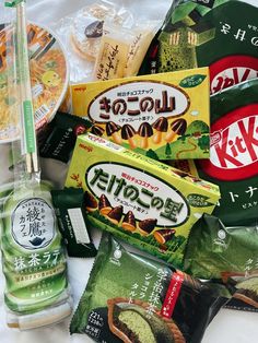 various snacks and condiments laid out on a white tablecloth with japanese writing