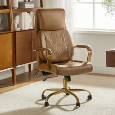 a brown leather office chair sitting on top of a white rug in front of a window