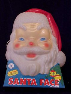 an old santa face toy with blue eyes