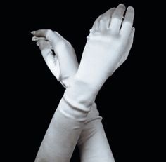 two hands with white gloves on top of each other