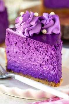 a slice of purple cake on a plate with a fork