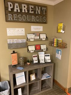 there is a display in the corner of this room with many books and papers on it