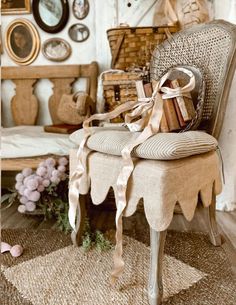 a chair with a bow on the back and some books sitting on top of it