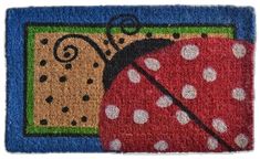 a door mat with a ladybug and polka dot design on the front side