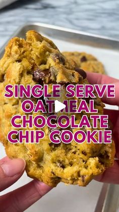 someone holding up a single serve oatmeal chocolate chip cookie