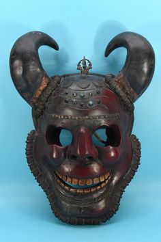 a mask with horns and eyes on a blue background