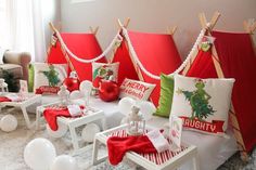 a room decorated for christmas with red and white decorations