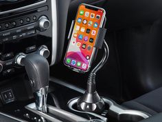 an iphone is hooked up to a car charger in the center of a vehicle