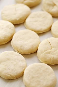 several uncooked cookies sitting on top of a baking sheet