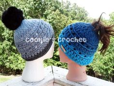 two crocheted hats with pom - poms are on top of each other