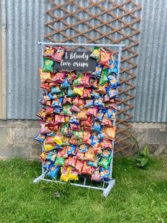 a sign made out of candy bars on the grass with a chalkboard attached to it