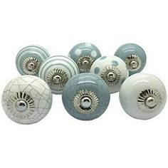 several white and blue knobs with holes in the middle, on a white background