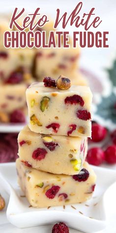 three pieces of white chocolate fudge stacked on top of each other with raspberries