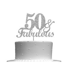 a 50th birthday cake topper with the number fifty and fabulous written in silver glitter