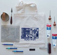 an assortment of crafting supplies laid out on top of a white table with scissors and other items