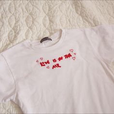 Love Is In The Air T-shirt ❤️
**comes with a free ring of your choice from my page**
———————-
• Embroidered White TShirt with Red Thread 
• tagged as a large, fits me as a medium perfectly oversized. message w measurements if needed 
• super soft tshirt small stain on bottom edge of the shirt, barely noticeable, on fourth pic 
• message with any questions :))

#valentines #love #mushrooms #madewithlove Red Thread, Love Is In The Air, White Tshirt, American Apparel, Women's T Shirt, Stain, Thread, Womens Tops, Women Accessories