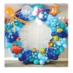 a blue balloon wreath with sea animals and fish on it