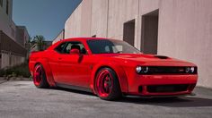 a red sports car parked in front of a building