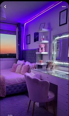 a bedroom with purple lighting and a large mirror on the wall above the bed that has a chair in front of it