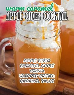 an apple cider cocktail in a mason jar with whipped cream and caramel garnish