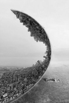 an aerial view of a city in the middle of nowhere, with a spiral staircase leading up to it