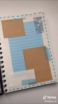 an open notebook with blue and white paper