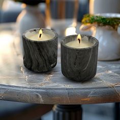 two candles sitting on top of a table