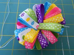 a colorful hair bow sitting on top of a cutting board