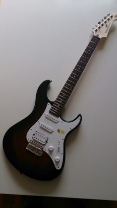 an electric guitar sitting on top of a table