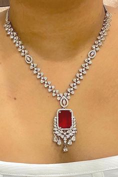 Gorgeous fine quality imitation jewellery  CZ Red with CZ diamonds studded necklace with white gold rhodium plating and matching Earrings Item contains: Necklace and earrings AAA quality cubic zirconia used. Highest quality and craftsmanship Necklace Fitting is adjustable Earrings Closure: Pushback Necklace Closure: chain with Hook Details-  -Handmade item -Delivery from a small business in India -Materials: white rhodium, stones, cz, zircon, American diamond -Jewellery type: Earrings, Necklace Dazzling Ruby Necklace With Sparkling Stones, Fine Ruby Jewelry For Celebration, Anniversary Diamond Gemstone Jewelry Sets, Fine Jewelry Ruby Sets, Fine Jewelry Sets With Hand Set Rubies, Red Diamond Pendant Necklace, Dazzling Hand-set Ruby Jewelry, Hand Set Ruby Jewelry Sets In Fine Jewelry Style, Red Diamond Cut Necklace