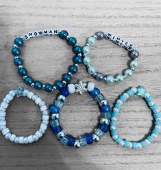 four bracelets with words on them sitting on a table