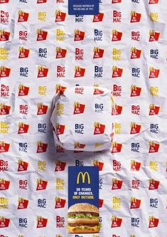 a mcdonald's big mac sandwich on top of a paper wrapper