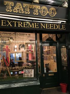 a tattoo shop front with the words extreme needle on it