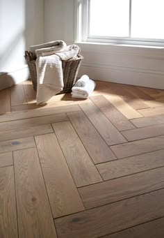 a bathroom with wood flooring and white towels