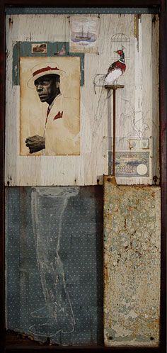 an altered photograph of a man's head and other items in a wooden frame