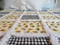 a bed topped with a black and white checkered bedspread