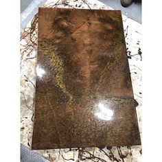 a marble table top with brown and white paint on it