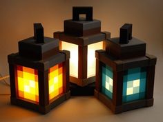 three lamps made out of legos sitting on top of a table