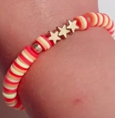 a close up of a person wearing a bracelet with stars on it