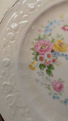 an old china plate with flowers painted on it