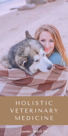 a woman laying on top of a blanket next to a dog under a blanket that says holstic veterinary medicine