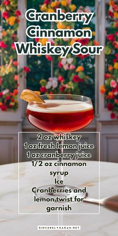 an advertisement for the cranberry, cinnamon and whiskey sour cocktail on a table with flowers in the background