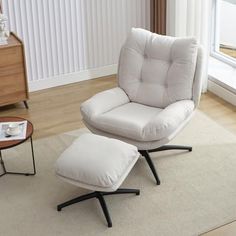 a white chair and ottoman in a living room