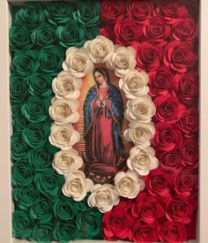 an image of the virgin mary surrounded by red, white and green roses in a shadow box